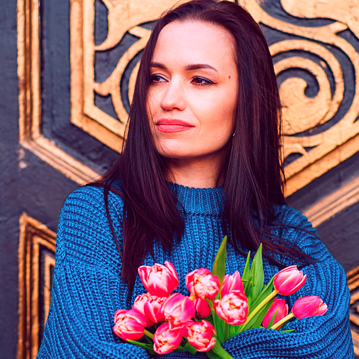 A woman holding pink tulips